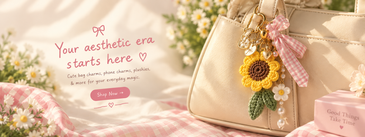 A beige handbag with decorative charms, including a crocheted sunflower, a pink gingham bow, and white daisy flowers, styled on a pink-and-white checkered blanket with daisies. Text on the left reads, 'Your aesthetic era starts here' with a pink 'Shop Now' button.