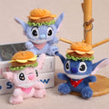 Plush toys resembling cartoon characters with hamburger hats on a neutral background