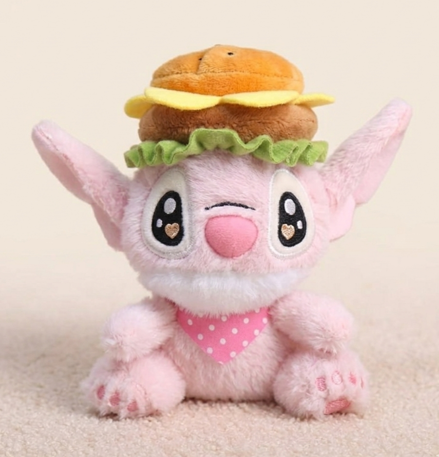 Plush toy with a hamburger on its head against a beige background