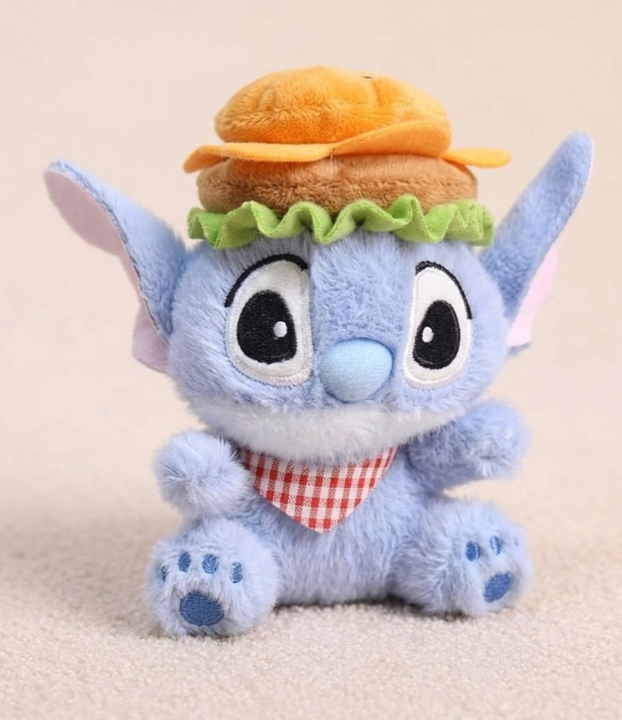 Plush toy resembling a character with a hamburger hat on a beige background