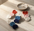 Set of colorful crocheted hair clips on a wooden surface