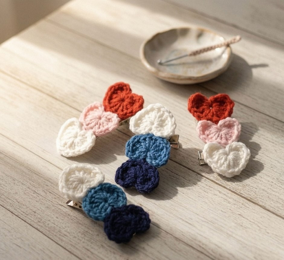 Set of colorful crocheted hair clips on a wooden surface